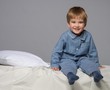 Little boy wearing blue pyjamas in bed