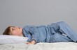 Little boy wearing blue pyjamas in bed