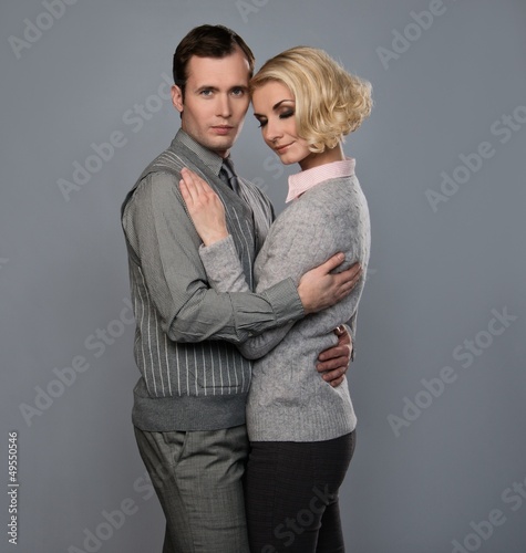 Photo: Elegant couple isolated on grey background Elegant couple isolated on grey background