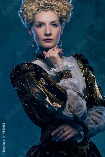 Photo: Haughty queen in royal dress Haughty queen in royal dress