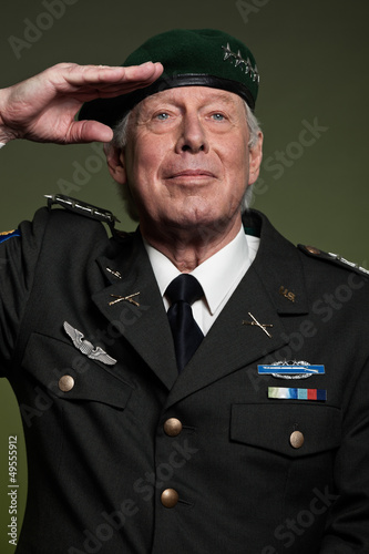 Photo: US military general wearing beret. Salutation. Studio portrait. US military general wearing beret. Salutation. Studio portrait.