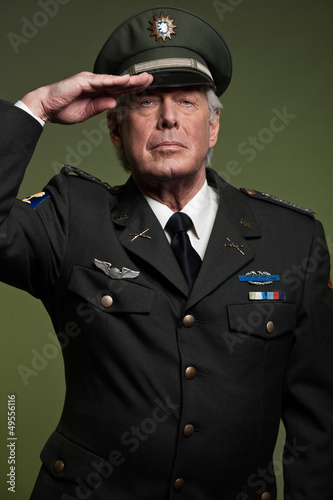 Photo: US military general wearing cap. Salutation. Studio portrait. US military general wearing cap. Salutation. Studio portrait.