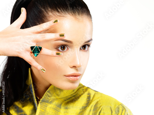 Photo: woman with golden nails and precious stone emerald woman with golden nails and precious stone emerald