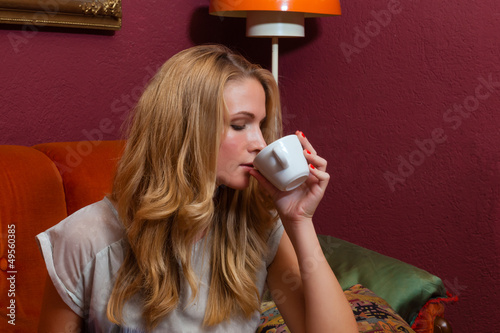 Photo: Young woman drinking a coffee or cappuccino Young woman drinking a coffee or cappuccino