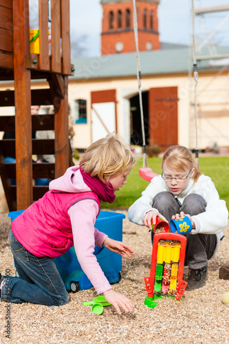 Photo: Girls playing on the playground having fun Girls playing on the playground having fun