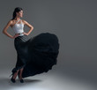 girl dances in a black silk skirt