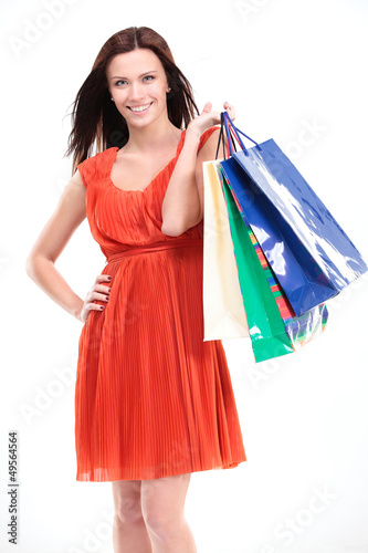 Photo: Portrait of young happy smiling woman with shopping bags Portrait of young happy smiling woman with shopping bags