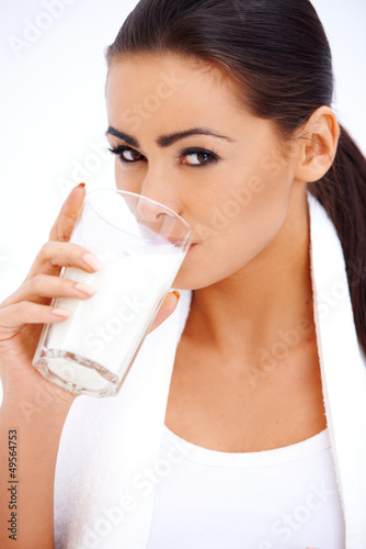 Photo: Woman is drinking milk from a glass Woman is drinking milk from a glass