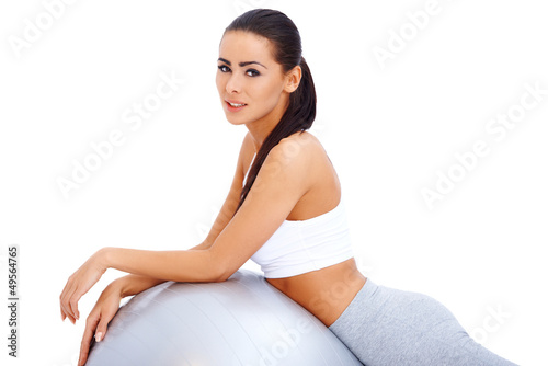 Photo: Cute brunette relaxing after exercises Cute brunette relaxing after exercises