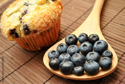 Photo: Blueberries Next to a Blueberry Muffin Blueberries Next to a Blueberry Muffin