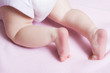 Baby girl crawling away on a blanket