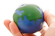 Photo: hand holding a global model toy hand holding a global model toy