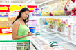 Woman buying ice-cream at the supermarket