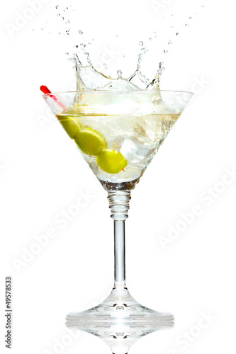 Photo: Olive splashing on martini glass isolated on white Olive splashing on martini glass isolated on white