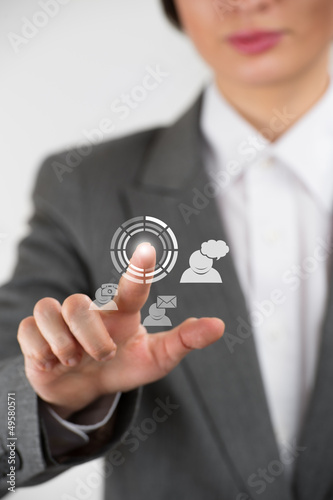 Photo: Business woman pointing her fingers on virtual web interface ico Business woman pointing her fingers on virtual web interface ico