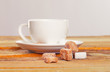Image of coffee cup in front of sugar pieces
