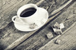 Black and white image of coffee cup and sugar