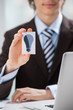 Detail shot - business man showing business card with idea symbo
