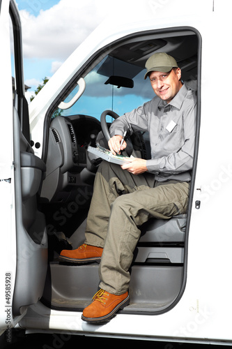 Photo: Handsome truck driver. Handsome truck driver.