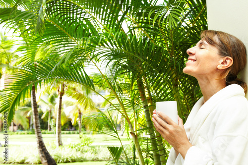 Photo: Woman in the tropical garden. Woman in the tropical garden.