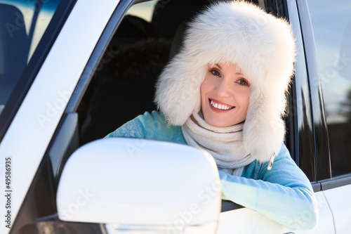 Photo: Happy woman in white fur hat in a car Happy woman in white fur hat in a car