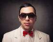 Photo: Portrait of young elegant nerd with sunglasses Portrait of young elegant nerd with sunglasses