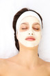 Young woman with clay facial mask