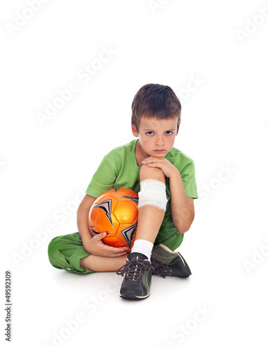 Photo: Boy with injured leg and soccer ball Boy with injured leg and soccer ball