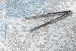 A pair of compasses on an aeronautical navigational chart