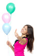 woman with balloons smiling and showing thumb up