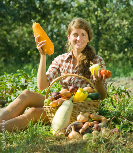 Photo: girl sitting near basket of harvest girl sitting near basket of harvest