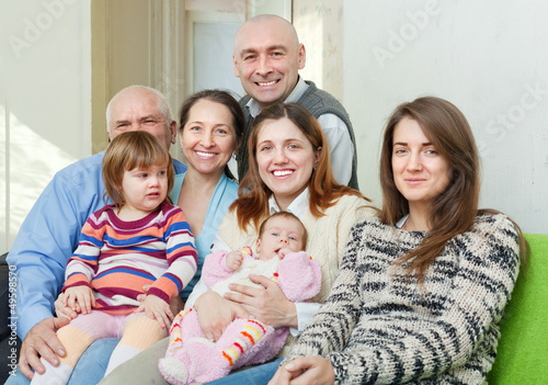 Photo: Portrait of cheerful three generations family Portrait of cheerful three generations family
