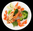 Salmon steak with vegetables isolated on black