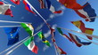Flags waving in the wind against blue sky