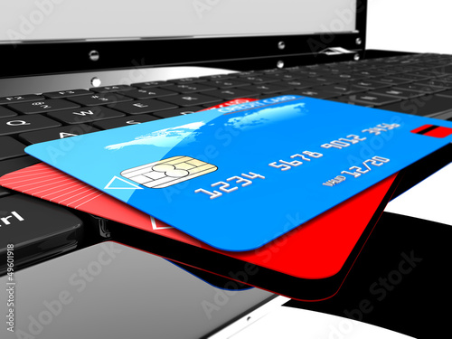 Illustration: Two credit cards on laptop Two credit cards on laptop