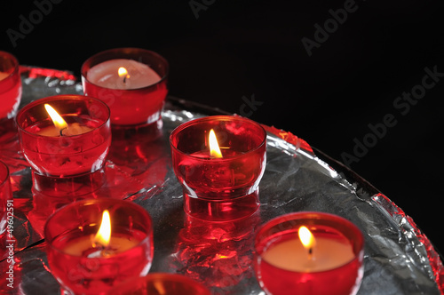 Photo: Church candles in red transparent chandeliers Church candles in red transparent chandeliers