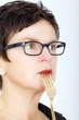 Photo: Woman with fork to your mouth Woman with fork to your mouth