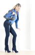 standing woman wearing blue clothes with handbag