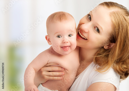 Photo: happy family. young mother with baby happy family. young mother with baby