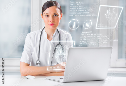 Photo: Doctor with hightech computer screen viewing patient data Doctor with hightech computer screen viewing patient data