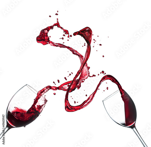 Photo: Concept of red wine splashing from glasses on white background Concept of red wine splashing from glasses on white background