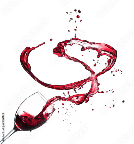 Photo: Red wine splashing from glass, isolated on white background Red wine splashing from glass, isolated on white background