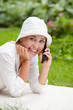 Photo: Woman with mobile phone, outside Woman with mobile phone, outside