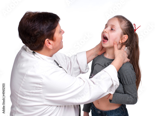 Photo: Senior pediatrician examing girl's throat Senior pediatrician examing girl's throat
