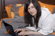 Woman in bed with a netbook