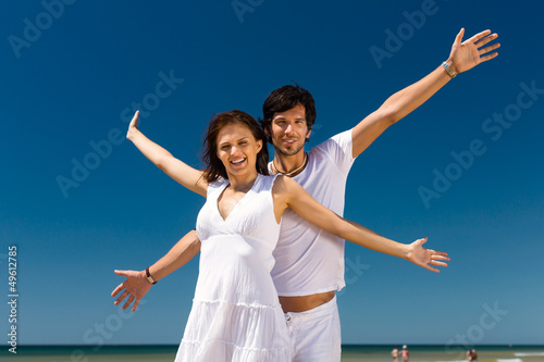 Photo: Couple enjoying freedom on the beach Couple enjoying freedom on the beach