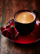 Cup of espresso with red rose