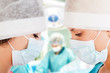 Two female surgeon with nurse in operation room