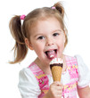joyful child girl eating ice cream in studio isolated