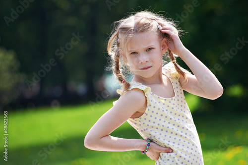 Photo: Portrait of young girl on summer sunny landscape Portrait of young girl on summer sunny landscape